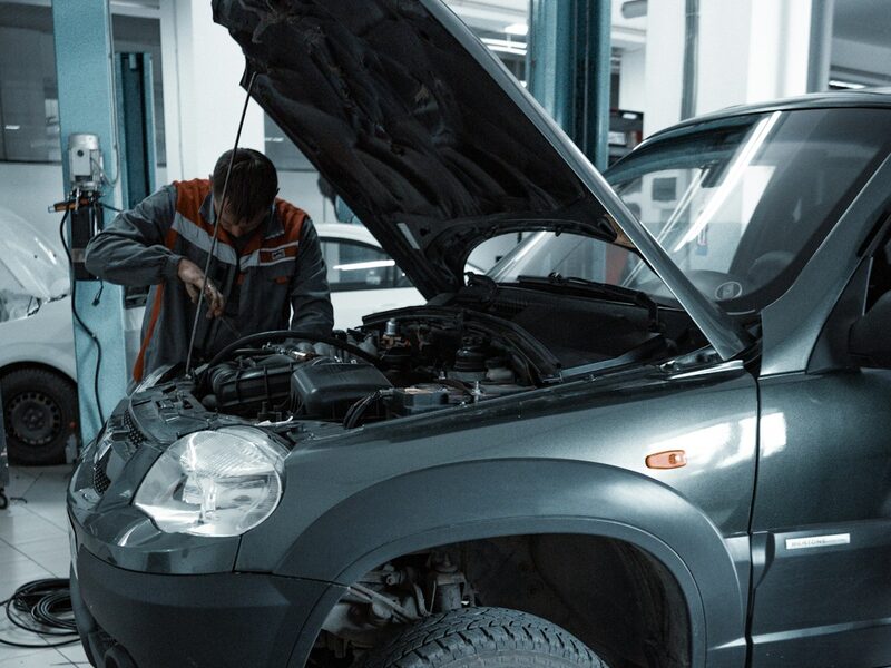 A vehicle in the service bay with the hood up